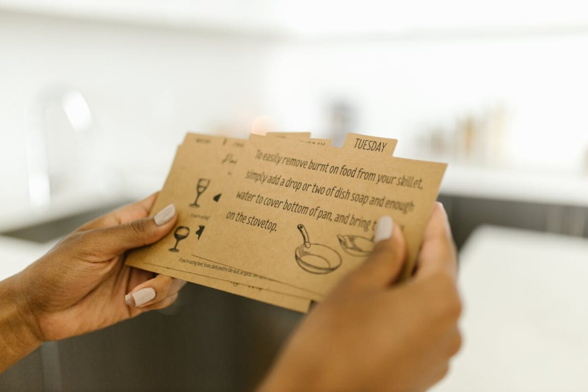 Woman holding instructional cards with text and illustrations.